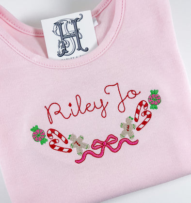 Christmas Candy Canes, Wrapped Candy, and Gingerbread Man Embroidery Personalized on Girl's Pink Ruffled Shirt